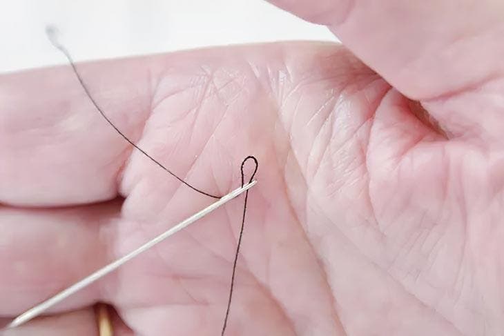 Tip of the palm of the hand to thread a needle