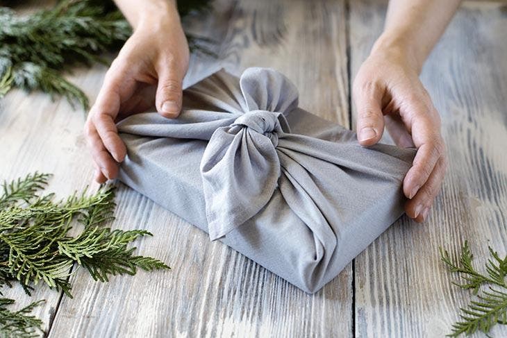 Gift wrapped in gray cloth.