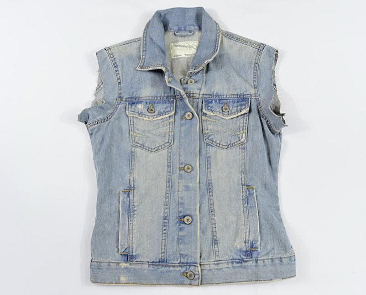 Cut off the sleeves of the jean jacket.