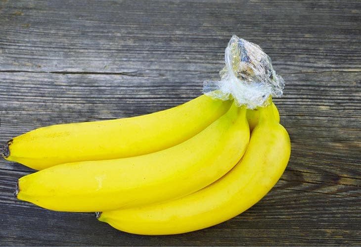 Wrap the banana stem in plastic wrap