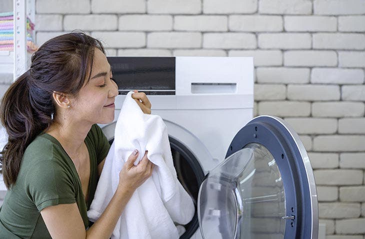 Mujer disfrutando del olor de su ropa