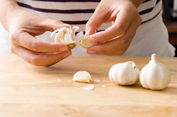 woman peeling garlic