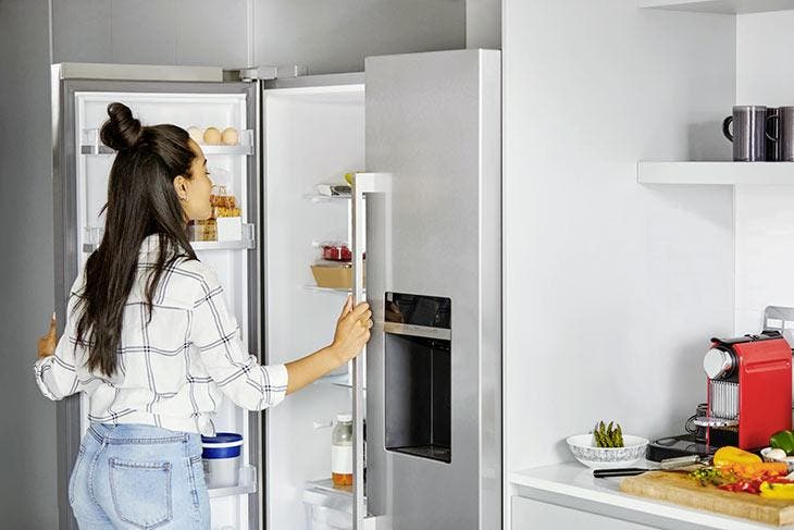 Woman in front of an open refrigerator