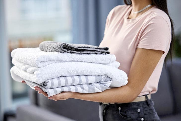 Woman holding folded towels