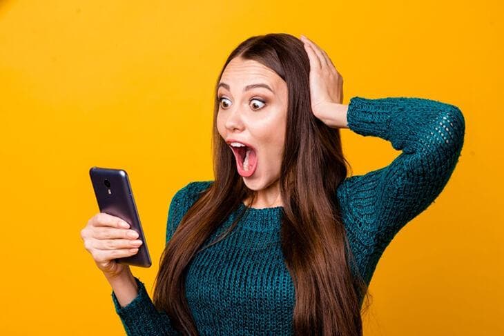 Surprised woman with present selfie in her photo gallery
