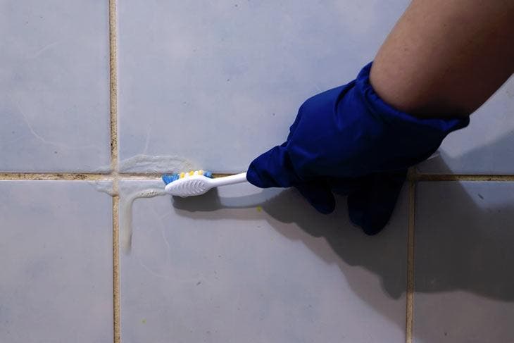 Scrub tile joints with a toothbrush