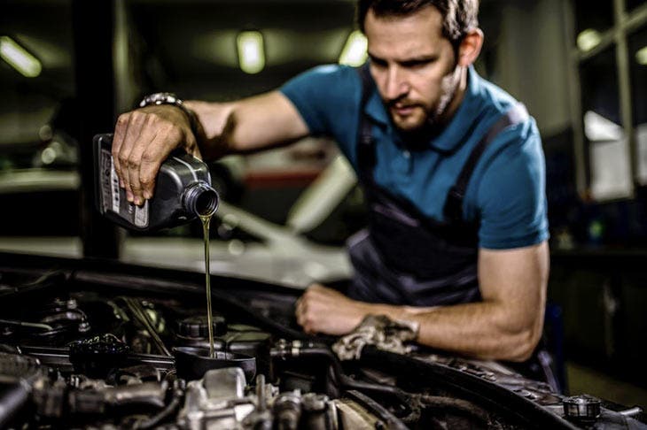 Mechanic changes engine oil