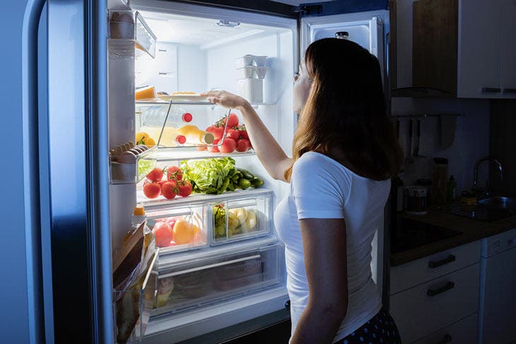 Close-up De La Personne Essayant D'ouvrir Frigo Fermé Avec Chaîne