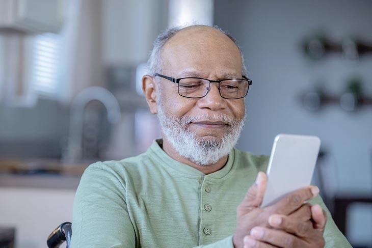 Old man holding a smart phone