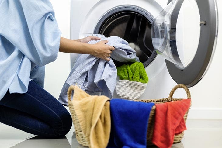Take clean clothes out of the washing machine