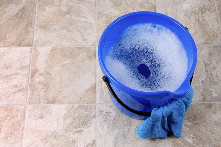 Water bucket with cleaning water and a rag