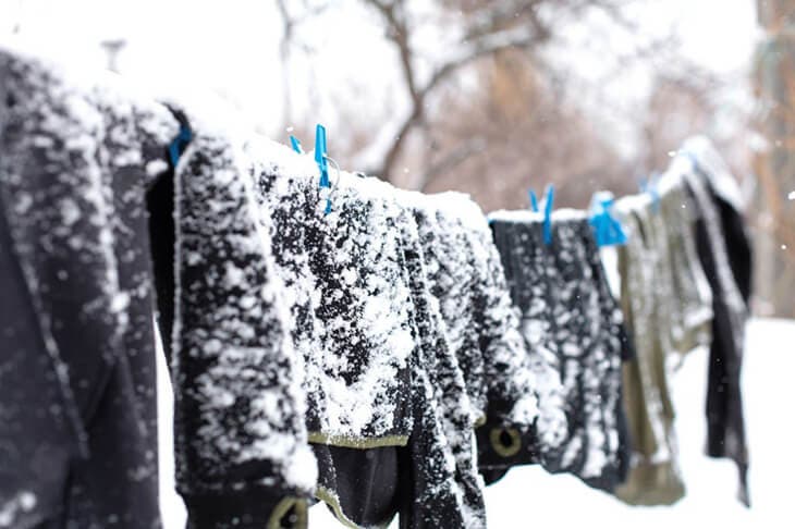 Dry clothes outdoors during snowfall