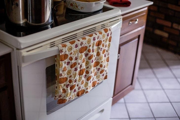 Kitchen towel hanging on the oven door