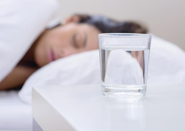 A glass of water on the nightstand