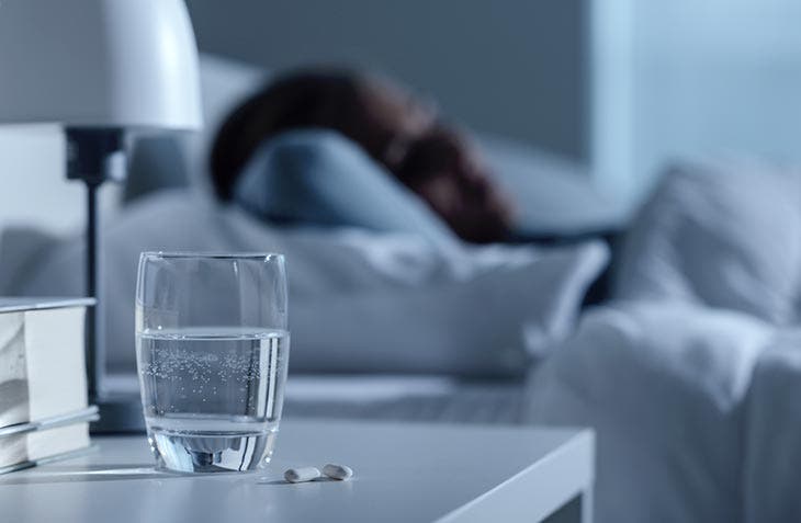 A glass of water on the bedside table