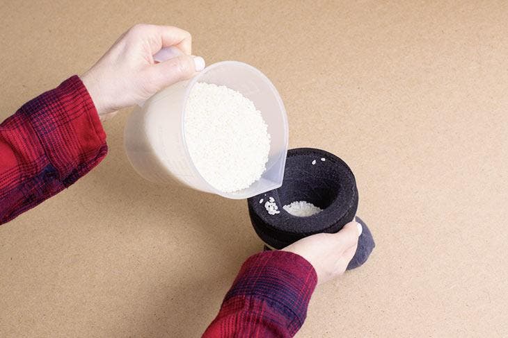 Pouring rice into socks