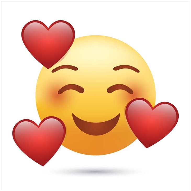 Emoji d’un visage souriant entouré de cœurs