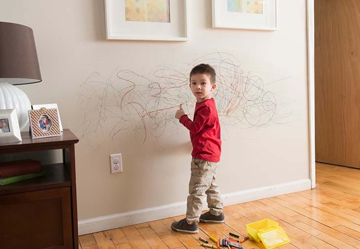 niño dibuja paredes