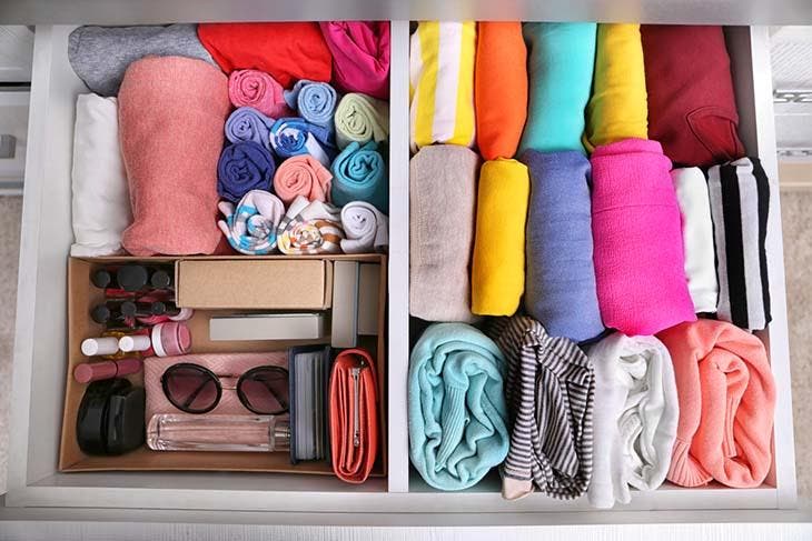 neatly folded clothes in a closet